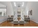 Bright and airy living room featuring skylights, a decorative chandelier, a fireplace, and stylish neutral furnishings at 103 Ticonderoga Rd, Cary, NC 27519