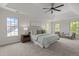 Large main bedroom with a tray ceiling, carpet floors, and natural light from many windows at 103 Ticonderoga Rd, Cary, NC 27519