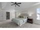 Large main bedroom with a tray ceiling, natural light, carpet floors, and an ensuite bath at 103 Ticonderoga Rd, Cary, NC 27519