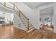Traditional staircase with hardwood floors and white railings leading to the upper level at 103 Ticonderoga Rd, Cary, NC 27519