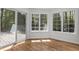 Cozy sunroom with bright windows and sliding door with wooded views at 103 Ticonderoga Rd, Cary, NC 27519