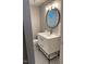 Bathroom featuring a modern vanity and a stylish round mirror at 1045 Nichols Dr, Raleigh, NC 27605