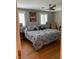 Main bedroom features hardwood floors, two windows, and a ceiling fan at 1045 Nichols Dr, Raleigh, NC 27605