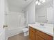 A well-lit bathroom with single vanity and shower-tub combo, showcasing a functional layout at 107 Kinship Ln, Apex, NC 27502