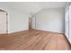 Empty primary bedroom with hardwood floors, vaulted ceiling, and ensuite bathroom access at 107 Kinship Ln, Apex, NC 27502