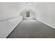 Spacious bedroom with a dormer window, built-in storage and soft carpeting at 107 Kinship Ln, Apex, NC 27502