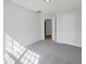 An airy bedroom with light gray carpet and neutral paint, features a doorway and a closet at 107 Kinship Ln, Apex, NC 27502