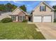 Charming single Gathering home featuring a two car garage, manicured lawn and brick accents at 107 Kinship Ln, Apex, NC 27502
