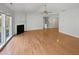 Spacious living room with hardwood floors, fireplace, staircase, and ceiling fan at 107 Kinship Ln, Apex, NC 27502