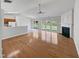 Open living room area with hardwood floors, fireplace, and backyard access at 107 Kinship Ln, Apex, NC 27502