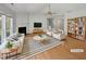 Bright living room featuring vaulted ceiling, fireplace, hardwood floors and neutral decor at 107 Kinship Ln, Apex, NC 27502