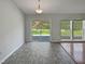 Bright living area with wood-style flooring, sliding doors and windows offering scenic views at 107 Kinship Ln, Apex, NC 27502