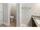 Half-bathroom features granite counters, toilet, and a pedestal sink at 108 Warm Wood Ln, Apex, NC 27539
