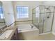 Bathroom with a bathtub, glass enclosed shower, and a sink with granite countertops at 108 Warm Wood Ln, Apex, NC 27539