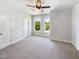 A light-filled bedroom features neutral walls, carpet, and windows letting in plenty of sunlight at 108 Warm Wood Ln, Apex, NC 27539