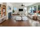Bright, staged living room with hardwood floors, fireplace, and abundant natural light at 108 Warm Wood Ln, Apex, NC 27539