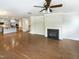 Open-concept living room with fireplace and hardwood floors connects to the gourmet kitchen at 108 Warm Wood Ln, Apex, NC 27539