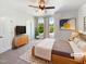 Bright main bedroom features a ceiling fan, stylish décor, and plenty of natural light at 108 Warm Wood Ln, Apex, NC 27539