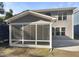 Relaxing screened-in sunroom offers a seamless transition to the outdoor patio at 108 Warm Wood Ln, Apex, NC 27539