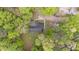 An aerial view of a home surrounded by lush greenery, showcasing its location within a wooded area at 1106 Lake Ridge Dr, Creedmoor, NC 27522
