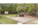 A concrete backyard basketball court, a shed, and wooden privacy fencing create a secluded backyard space at 1106 Lake Ridge Dr, Creedmoor, NC 27522