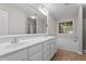 Bathroom with double sink vanity, large mirror, and separate bathtub at 1106 Lake Ridge Dr, Creedmoor, NC 27522