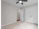 Bedroom with ceiling fan, neutral carpet and paint, and double door closet at 1106 Lake Ridge Dr, Creedmoor, NC 27522