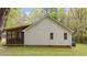 Home exterior with a screened-in porch, featuring a well-maintained lawn and trees at 1106 Lake Ridge Dr, Creedmoor, NC 27522