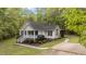 Home with a welcoming front porch, landscaped garden, and a sidewalk at 1106 Lake Ridge Dr, Creedmoor, NC 27522