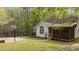 Charming home with a screened porch and basketball court surrounded by lush greenery at 1106 Lake Ridge Dr, Creedmoor, NC 27522
