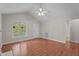 Well-lit living room with a vaulted ceiling, a ceiling fan, hardwood floors, and a view to the outdoors at 1106 Lake Ridge Dr, Creedmoor, NC 27522