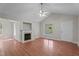 Bright living room featuring a fireplace, ceiling fan, and large window offering a scenic outdoor view at 1106 Lake Ridge Dr, Creedmoor, NC 27522