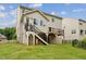 Home exterior showcasing a spacious backyard with a deck and stairs at 1216 Edgemoore Trl, Wake Forest, NC 27587