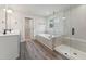 Bathroom featuring double sinks, a soaking tub, and a glass-enclosed shower at 1216 Edgemoore Trl, Wake Forest, NC 27587