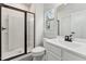 Bathroom with glass enclosed shower, wood look flooring and white cabinets at 1216 Edgemoore Trl, Wake Forest, NC 27587