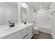 Bathroom featuring double sinks, a tub with shower and tile surround at 1216 Edgemoore Trl, Wake Forest, NC 27587