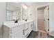 Bathroom with double sinks, black hardware and wood look flooring at 1216 Edgemoore Trl, Wake Forest, NC 27587