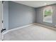 Bedroom painted a dark gray with white trim, carpet and a window at 1216 Edgemoore Trl, Wake Forest, NC 27587