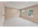 Neutral bedroom with two windows, plush carpet, and fresh paint at 1216 Edgemoore Trl, Wake Forest, NC 27587