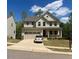 Charming two-story home with manicured lawn, two-car garage, and car parked on the driveway at 1216 Edgemoore Trl, Wake Forest, NC 27587