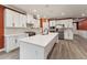 A modern kitchen features white cabinets, stainless steel appliances, and a large island at 1216 Edgemoore Trl, Wake Forest, NC 27587