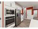 A view of the stainless steel appliances in the modern kitchen with white cabinets at 1216 Edgemoore Trl, Wake Forest, NC 27587