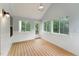 Inviting sunroom with wood floors and multiple windows at 1216 Edgemoore Trl, Wake Forest, NC 27587