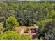 Aerial shot of home featuring well-maintained roof, driveway, and verdant trees at 1318 Indian Camp Rd, Chapel Hill, NC 27516