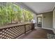 An inviting porch, with views of the lush green backyard and outbuilding at 1318 Indian Camp Rd, Chapel Hill, NC 27516