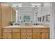 Bathroom featuring a double sink vanity and an expansive mirror at 1318 Indian Camp Rd, Chapel Hill, NC 27516