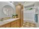 Bathroom with large vanity and neutral colored tiled floor and shower at 1318 Indian Camp Rd, Chapel Hill, NC 27516