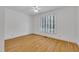 Bright bedroom featuring hardwood floors, fresh white paint, and a large window at 1318 Indian Camp Rd, Chapel Hill, NC 27516