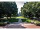 Picturesque campus green with a tree-lined walkway leading to a stately building at 1318 Indian Camp Rd, Chapel Hill, NC 27516
