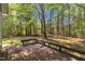 Inviting wooden deck with built-in seating overlooking a lush, green backyard at 1318 Indian Camp Rd, Chapel Hill, NC 27516